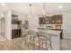 Modern kitchen with an island, stainless steel appliances and quartz countertops at 15436 Trinity Fall Way, Bradenton, FL 34212