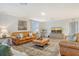 Relaxing living room with two leather couches and a large TV at 15436 Trinity Fall Way, Bradenton, FL 34212