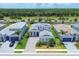 Community overview featuring multiple homes and lush landscaping at 8175 Redonda Loop, Lakewood Ranch, FL 34202