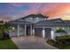 Two-story home with gray double-car garage and landscaped yard at 8175 Redonda Loop, Lakewood Ranch, FL 34202