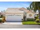 Cute cottage style home with white garage door and landscaping at 1350 Capri Isles Blvd # 54, Venice, FL 34292