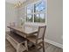 Dining room with farmhouse table and bench seating at 16232 Pine Mist Dr, Bradenton, FL 34211