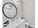 Bathroom with a round mirror and white vanity at 16518 Cornwall Ln, Bradenton, FL 34202