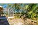 Backyard with screened enclosure, stone patio, and water feature at 2818 48Th E Way, Bradenton, FL 34203