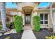 Elegant entryway with double doors and manicured landscaping at 8019 Royal Birkdale Cir, Lakewood Ranch, FL 34202