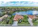 Luxury home with lake view and lush landscaping in a upscale community at 8019 Royal Birkdale Cir, Lakewood Ranch, FL 34202