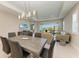 Open concept dining room with grey wood table and access to back yard at 4133 Golden Creek Ter, Parrish, FL 34219