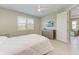 Bright bedroom with a queen bed, dresser and access to other rooms at 4133 Golden Creek Ter, Parrish, FL 34219