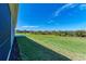 Grass backyard with view of other homes at 4133 Golden Creek Ter, Parrish, FL 34219
