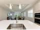 Open concept kitchen with island and stainless steel sink at 4133 Golden Creek Ter, Parrish, FL 34219