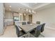 Modern dining room with grey wood table and six black leather chairs at 4133 Golden Creek Ter, Parrish, FL 34219