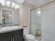 Modern bathroom with walk-in shower and dark vanity at 6417 Meadowlark Ln # 6417, Bradenton, FL 34210