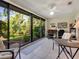 Relaxing sunroom workspace with garden views and ample natural light at 6417 Meadowlark Ln # 6417, Bradenton, FL 34210