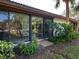 Sliding glass doors open to a patio, lush landscaping, and a serene outdoor setting at 6417 Meadowlark Ln # 6417, Bradenton, FL 34210