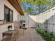 Relaxing patio with brick pavers, wicker chairs, and grill at 6417 Meadowlark Ln # 6417, Bradenton, FL 34210