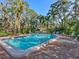 Inviting community pool with surrounding lounge chairs and tropical landscaping at 6417 Meadowlark Ln # 6417, Bradenton, FL 34210