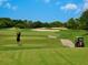 Golfer teeing off on a lush green golf course at 6417 Meadowlark Ln # 6417, Bradenton, FL 34210