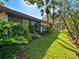 Landscaped backyard with tropical plants and canal view at 6417 Meadowlark Ln # 6417, Bradenton, FL 34210