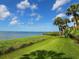 Stunning view of the water, lush grass, and palm trees at 6417 Meadowlark Ln # 6417, Bradenton, FL 34210