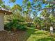 Landscaped backyard with lush greenery and water view at 6417 Meadowlark Ln # 6417, Bradenton, FL 34210