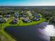 Aerial view of a community with houses, lake, and lush greenery at 9223 54Th E Ct, Parrish, FL 34219