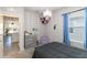 Small bedroom with gray carpet, dresser, and a view into kitchen at 9066 Royal River Cir, Parrish, FL 34219