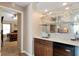 Home bar with glass shelving, a granite countertop, and a mini-fridge at 4966 Clubview E Ct, Bradenton, FL 34203