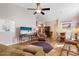 Spacious living room with hardwood floors, comfortable seating, and large TV at 4966 Clubview E Ct, Bradenton, FL 34203
