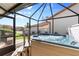 Relaxing hot tub in screened enclosure with backyard view at 4966 Clubview E Ct, Bradenton, FL 34203