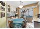 Bright eat-in kitchen with white cabinets, tile backsplash, and view of hot tub at 4966 Clubview E Ct, Bradenton, FL 34203