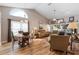 Open living and dining area with vaulted ceilings and hardwood floors at 4966 Clubview E Ct, Bradenton, FL 34203