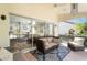 Relaxing screened porch with wicker furniture and view of backyard at 4966 Clubview E Ct, Bradenton, FL 34203