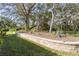 Landscaped retaining wall with various plants and trees at 4966 Clubview E Ct, Bradenton, FL 34203