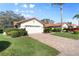 Inviting home exterior with a two-car garage and well-manicured lawn at 4966 Clubview E Ct, Bradenton, FL 34203