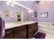 Elegant bathroom with double vanity, soaking tub, and decorative accents at 4966 Clubview E Ct, Bradenton, FL 34203