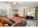 Spacious bedroom with a comfy bed and access to a patio at 4966 Clubview E Ct, Bradenton, FL 34203