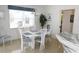 Bright dining room with white table and blue chairs near kitchen at 48 Sportsman Ct, Rotonda West, FL 33947