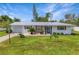 Ranch-style home with metal roof and landscaping at 4459 Beacon Dr, Sarasota, FL 34232