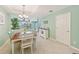 Bright dining room featuring a wooden table, white chairs, and a view to the living room at 4157 Overture Cir # 383, Bradenton, FL 34209