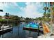 Calm waterway with several boats and lush green vegetation at 2607 Riverbluff Pkwy # V145, Sarasota, FL 34231