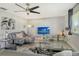 Spacious living area featuring a comfortable sectional sofa and large TV at 2607 Riverbluff Pkwy # V145, Sarasota, FL 34231