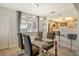 Elegant dining room, featuring a glass dining table and gray chairs at 2607 Riverbluff Pkwy # V145, Sarasota, FL 34231