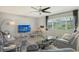 Living room with gray sectional sofa, coffee table, and large window at 2607 Riverbluff Pkwy # V145, Sarasota, FL 34231