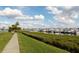 Scenic walkway with lush landscaping overlooks a marina filled with boats at 611 Riviera Dunes Way # 104, Palmetto, FL 34221