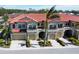 Three attached townhouses with tile roofs and attached garages at 228 Crew Ct, Sarasota, FL 34243