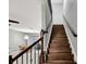 Dark wood staircase with metal railing, leading to upper level at 228 Crew Ct, Sarasota, FL 34243