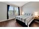 Spacious bedroom with large windows, dark flooring, and striped bedding at 228 Crew Ct, Sarasota, FL 34243