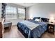 Bedroom with dark blue bedding, and cat-themed curtains at 228 Crew Ct, Sarasota, FL 34243