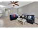 Living area features a navy sectional and access to the kitchen at 228 Crew Ct, Sarasota, FL 34243