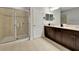 Bathroom with double vanity, large shower and dark cabinets at 228 Crew Ct, Sarasota, FL 34243